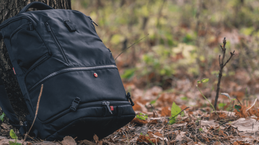 A backpack sitting on top of a wooden bench