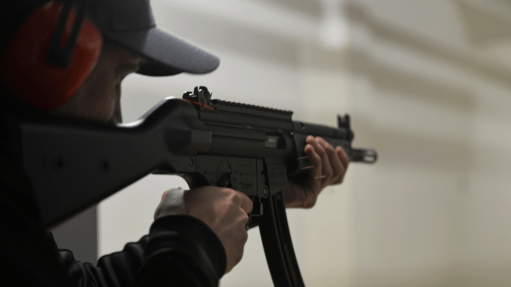 a person wearing headphones and holding a gun