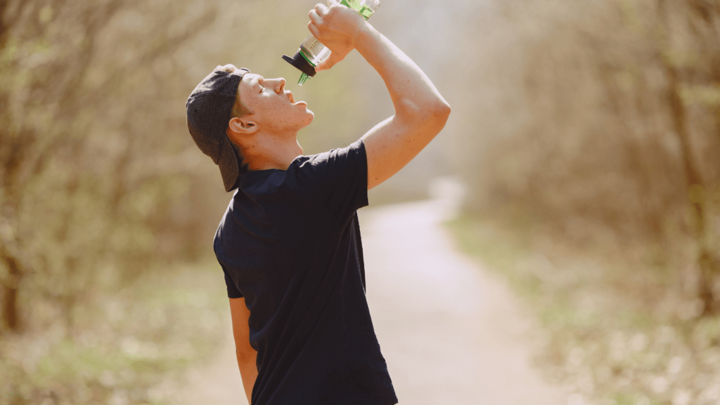 A person is drinking water from a water bottle