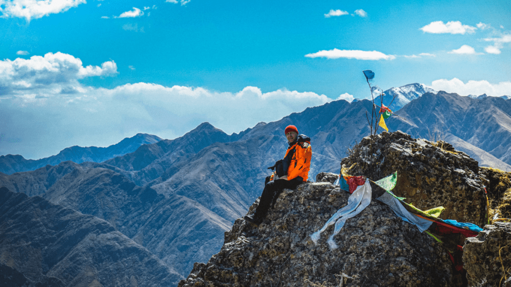 a person sitting on top of a mountain