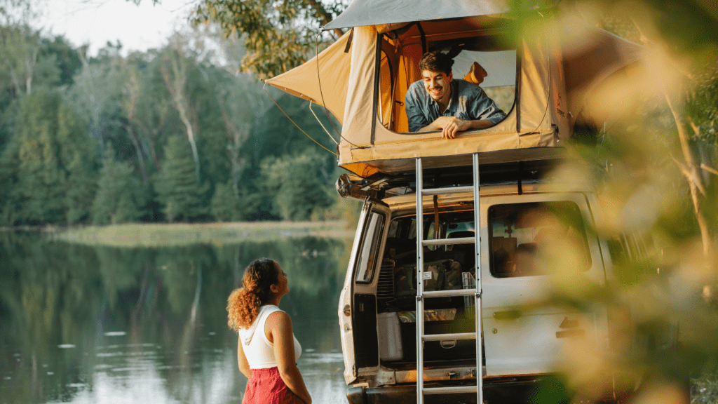 Two people standing in front of a van