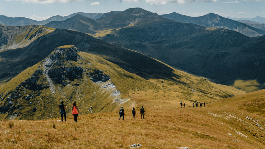 a group of people hiking in the mountains