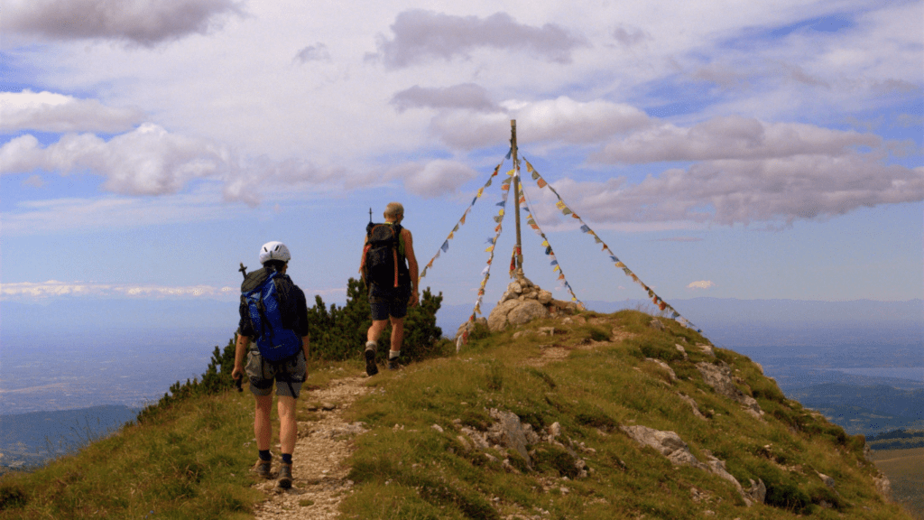 a group of people with backpacks walking on a trail