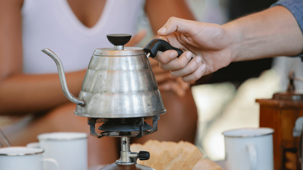 a person holding a kettle