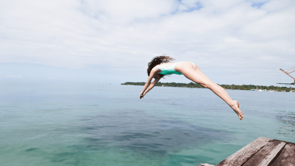 a person jumping on the cliff