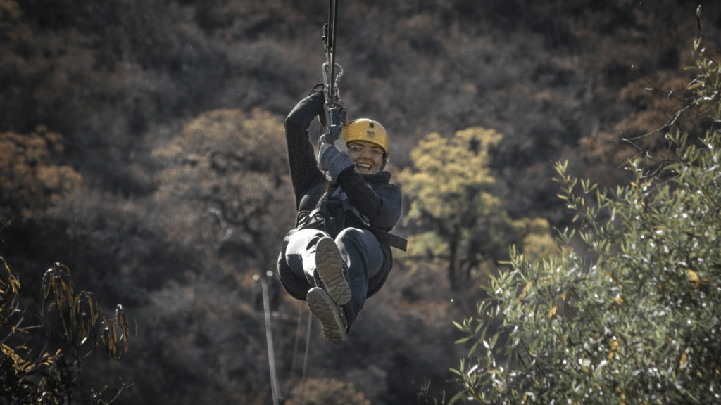 a person riding on a zipline