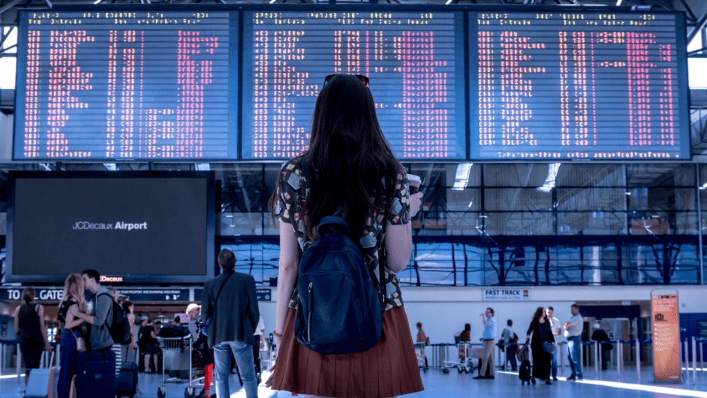 a person with a suitcase standing in front of a building