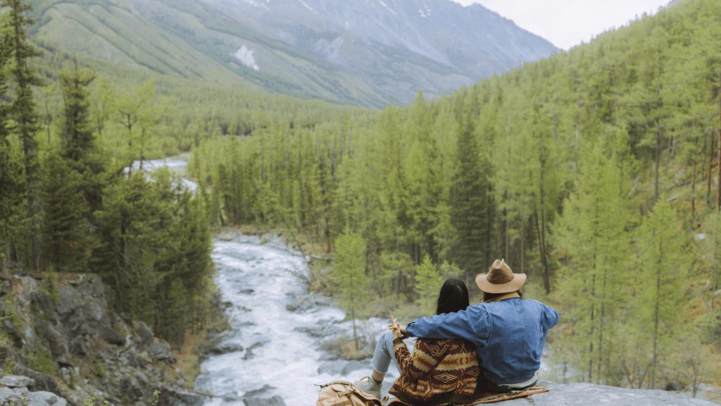 person sitting on the mountain