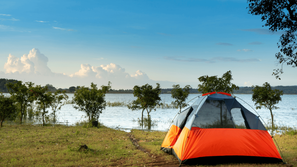 tents sit on top of a hill overlooking the ocean